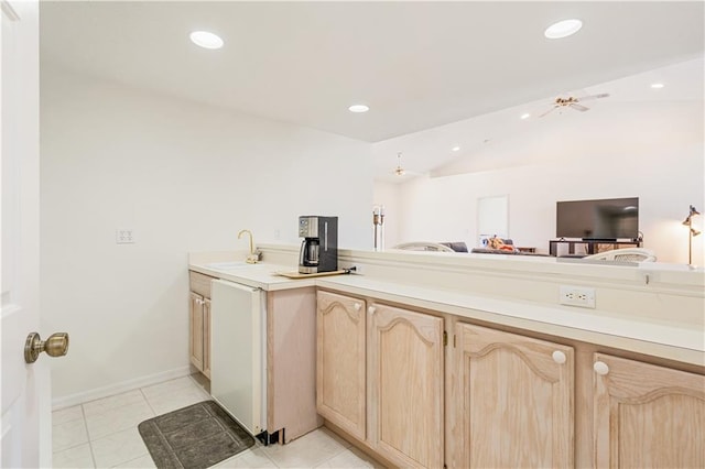 kitchen featuring light brown cabinetry, a sink, open floor plan, recessed lighting, and light tile patterned flooring