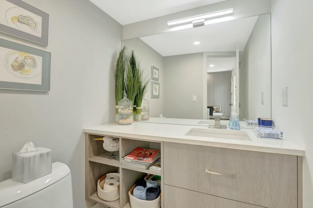 bathroom featuring toilet and vanity