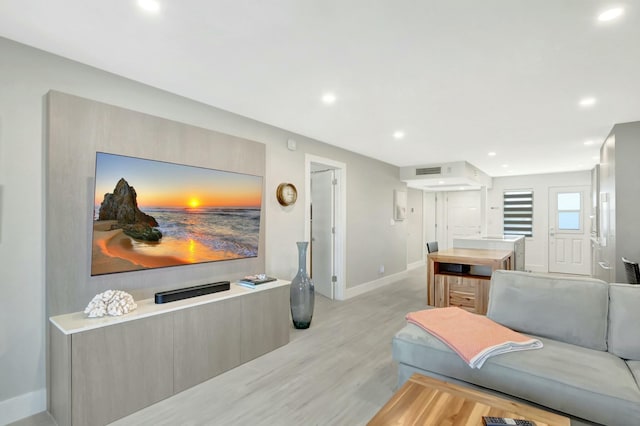 living room with baseboards, recessed lighting, visible vents, and light wood-type flooring