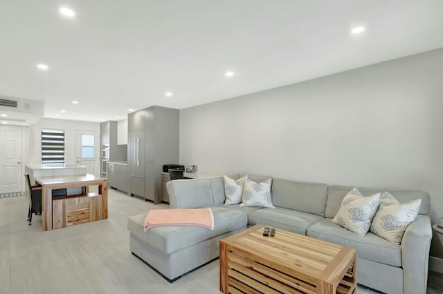 living area with recessed lighting and visible vents