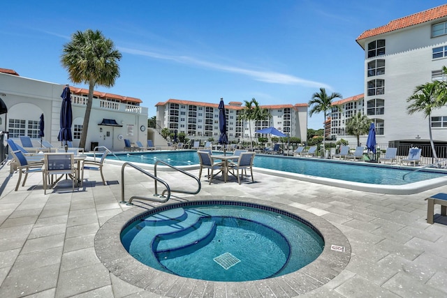 community pool featuring a patio and fence