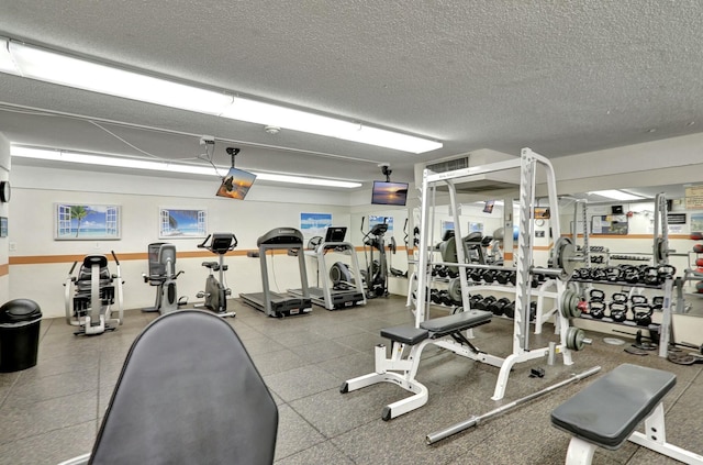 exercise room with a textured ceiling