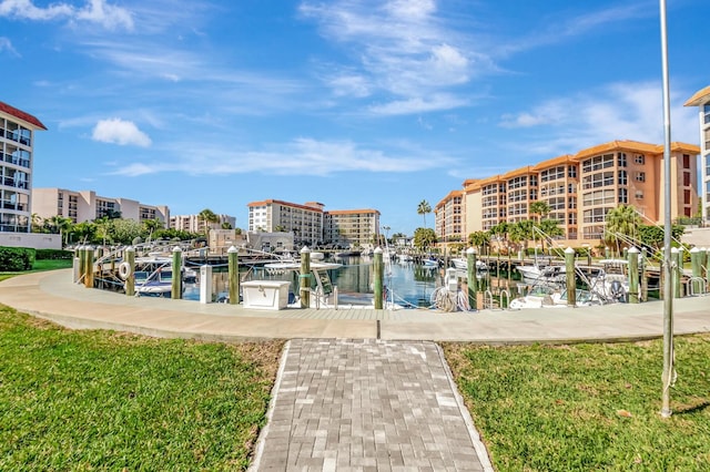 view of property's community featuring a water view and a dock