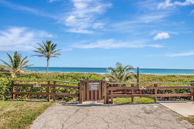 property view of water featuring a view of the beach and a gate