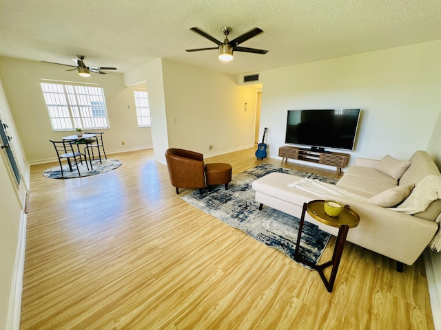 230 Normandy Ln E, Delray Beach, FL 33484 - living room with a ceiling fan, light wood-type flooring, a textured ceiling, and baseboards
