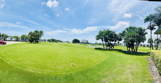 230 Normandy Ln E, Delray Beach, FL 33484 - view of community with golf course view, a putting green, a water view, and a yard