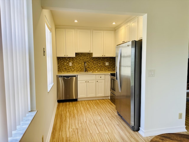 230 Normandy Ln E, Delray Beach, FL 33484 - kitchen featuring appliances with stainless steel finishes, white cabinetry, baseboards, light countertops, and recessed lighting