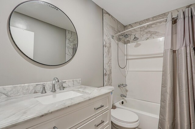 bathroom with vanity, toilet, and shower / bath combo with shower curtain