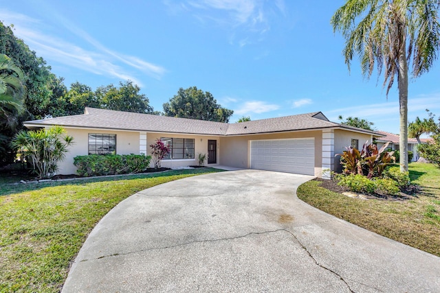 ranch-style house featuring stucco siding, an attached garage, concrete driveway, and a front yard