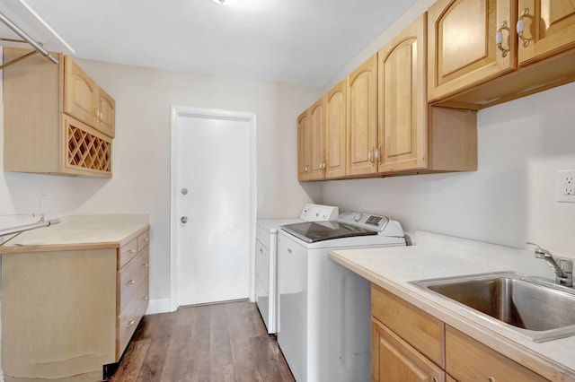 laundry area with a sink, cabinet space, dark wood finished floors, and washer and clothes dryer