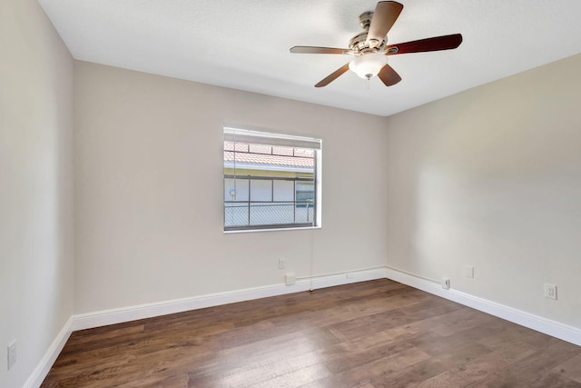 unfurnished room featuring baseboards, a ceiling fan, and wood finished floors