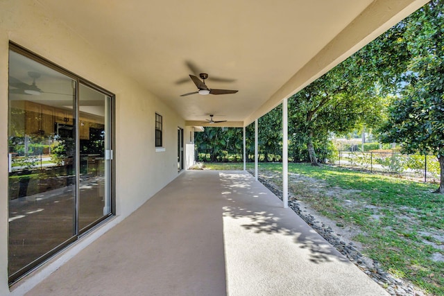 view of patio with ceiling fan and fence