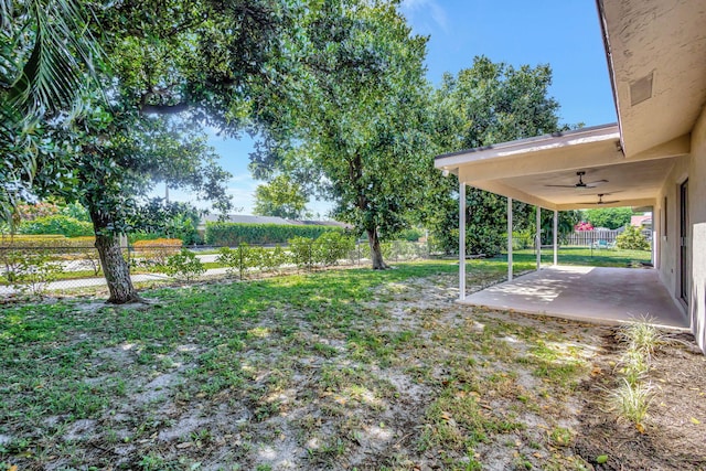 view of yard featuring a fenced backyard, a ceiling fan, and a patio area