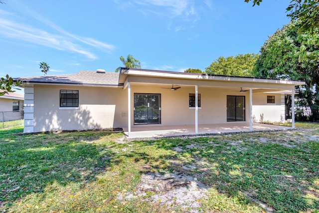 back of property featuring stucco siding, a patio, a yard, and ceiling fan