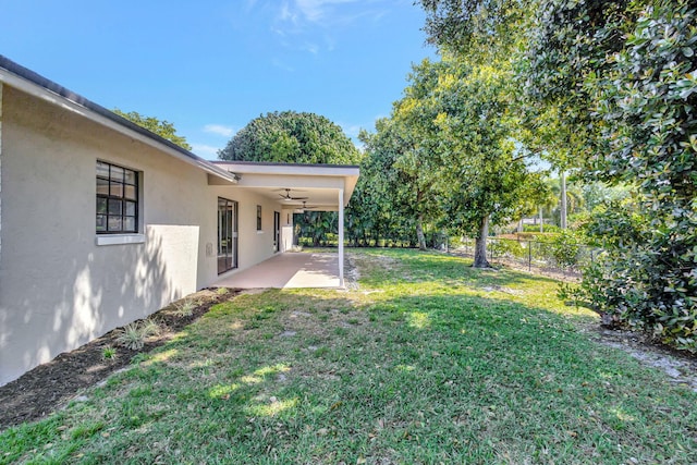 view of yard with a patio, a ceiling fan, and a fenced backyard