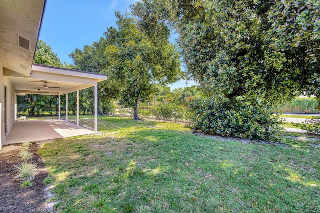 view of yard with a patio, a fenced backyard, and a ceiling fan