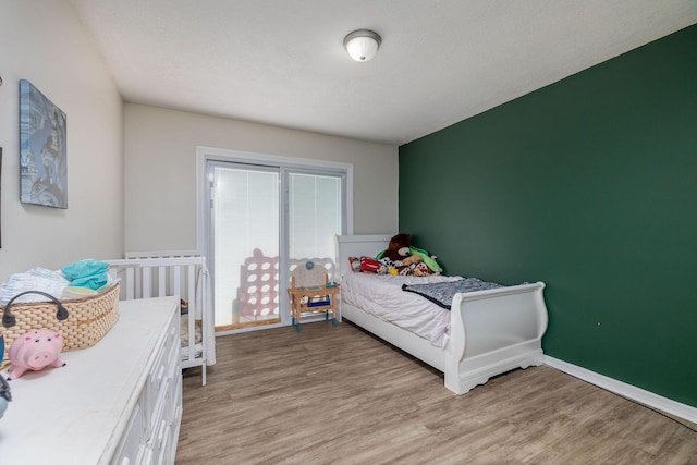 bedroom with light wood-style floors and baseboards