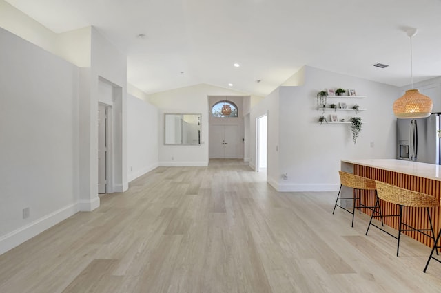 11287 Vivero Ave, Boynton Beach, FL 33437 - interior space with visible vents, baseboards, vaulted ceiling, and light wood-style floors