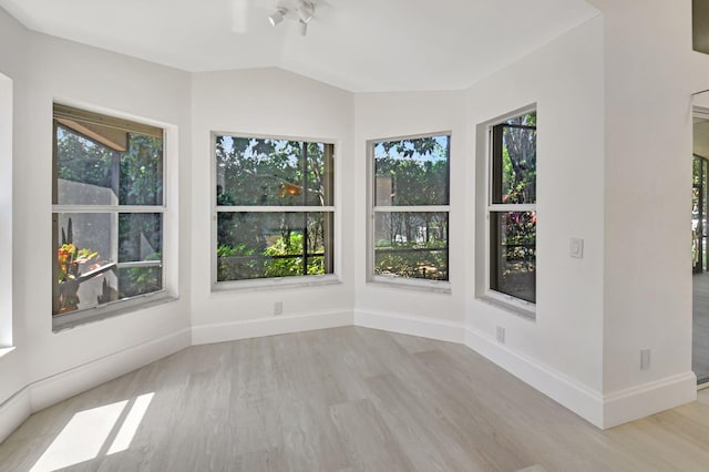 11287 Vivero Ave, Boynton Beach, FL 33437 - unfurnished sunroom featuring a wealth of natural light, lofted ceiling, wood finished floors, and baseboards
