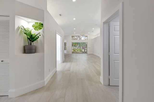 11287 Vivero Ave, Boynton Beach, FL 33437 - hallway with recessed lighting, baseboards, light wood finished floors, and vaulted ceiling
