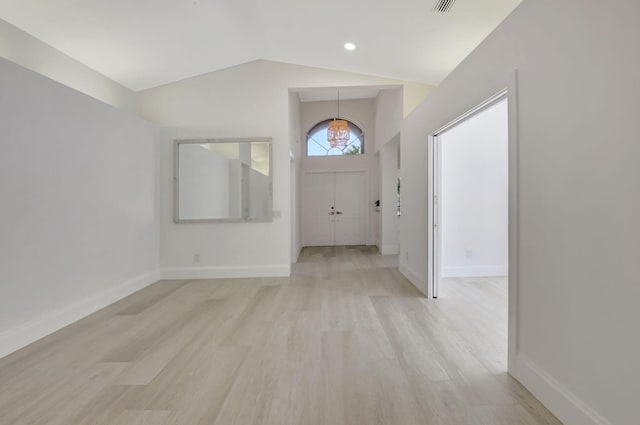 11287 Vivero Ave, Boynton Beach, FL 33437 - foyer entrance with baseboards, light wood-style floors, a chandelier, and vaulted ceiling