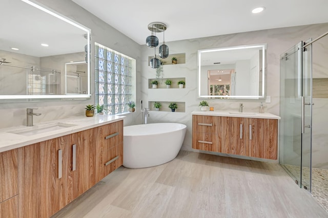 11287 Vivero Ave, Boynton Beach, FL 33437 - bathroom featuring a sink, two vanities, a freestanding tub, and a stall shower