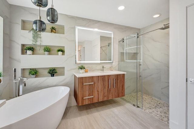 11287 Vivero Ave, Boynton Beach, FL 33437 - full bath featuring a freestanding tub, vanity, recessed lighting, a marble finish shower, and tile walls