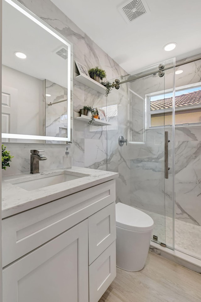 11287 Vivero Ave, Boynton Beach, FL 33437 - full bathroom featuring a marble finish shower, visible vents, toilet, and vanity