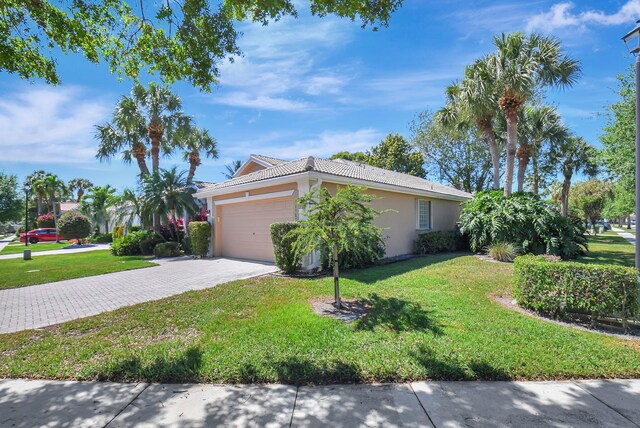 11287 Vivero Ave, Boynton Beach, FL 33437 - view of front of house with a front yard, driveway, a garage, and stucco siding