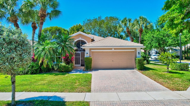 11287 Vivero Ave, Boynton Beach, FL 33437 - view of front of home with a front yard, a tiled roof, decorative driveway, and an attached garage