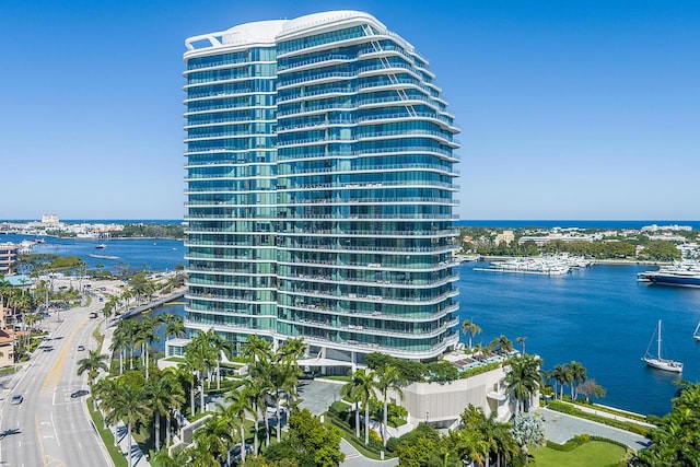 view of building exterior featuring a city view and a water view