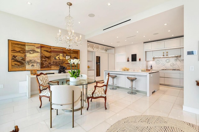 dining area featuring recessed lighting, baseboards, a notable chandelier, and light tile patterned flooring