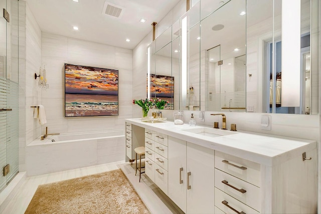 bathroom with a stall shower, a sink, tile walls, double vanity, and a bath