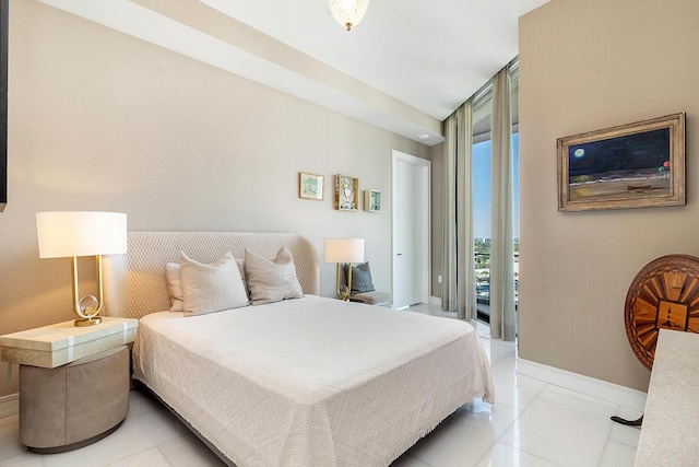 bedroom with light tile patterned flooring, floor to ceiling windows, and baseboards