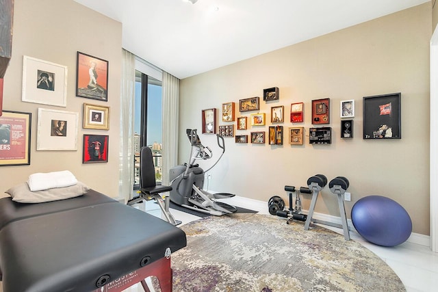 workout room with baseboards and expansive windows