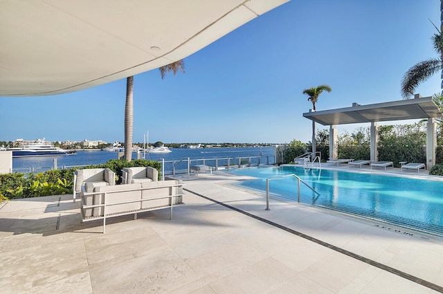 community pool featuring a water view and a patio area