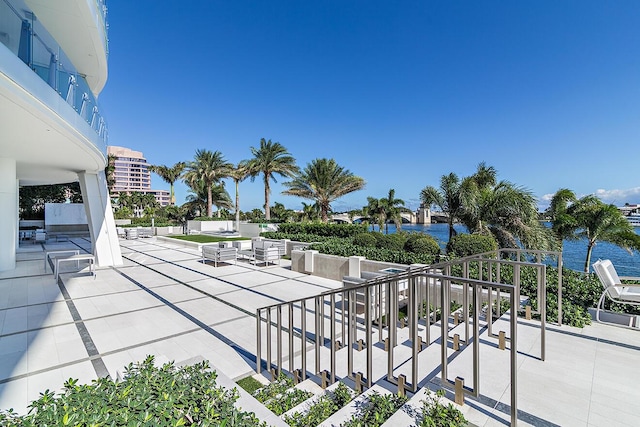 view of patio with a balcony and a water view