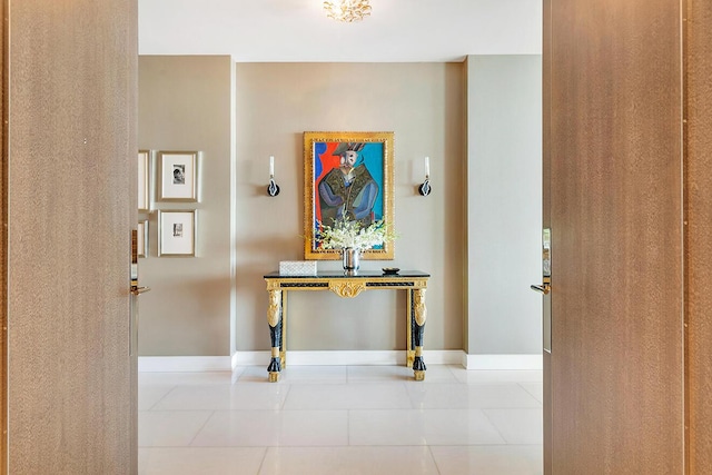 hallway with tile patterned floors and baseboards