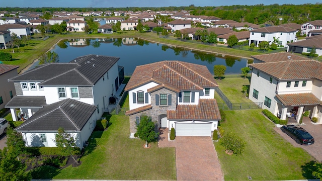 bird's eye view featuring a residential view and a water view