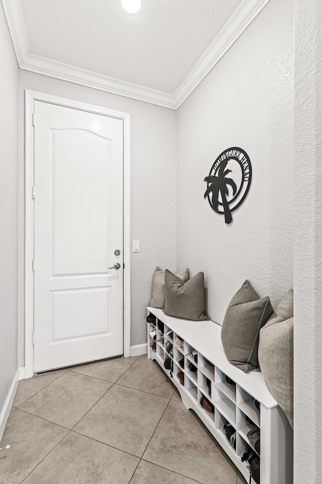 mudroom with light tile patterned flooring, baseboards, and ornamental molding