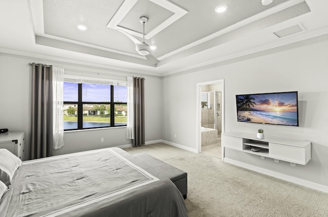 bedroom featuring baseboards, a raised ceiling, and light carpet