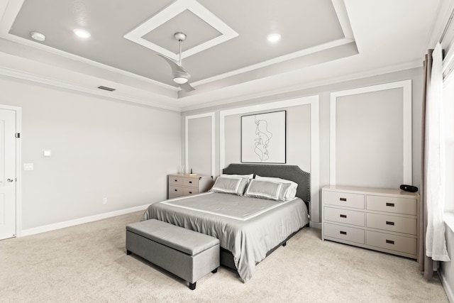 bedroom with a ceiling fan, a tray ceiling, crown molding, baseboards, and light colored carpet