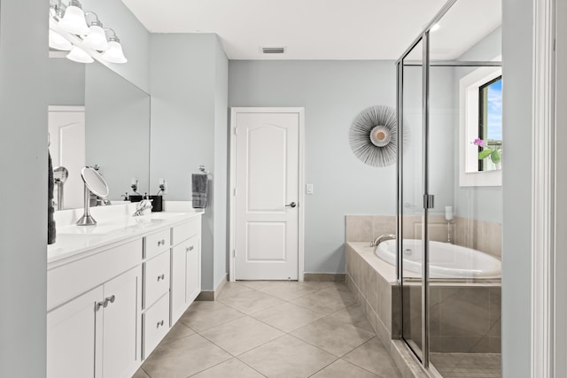 full bath with tile patterned floors, a garden tub, a sink, a shower stall, and double vanity