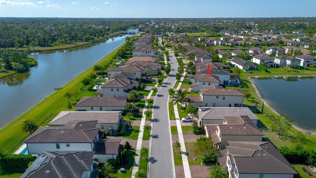 birds eye view of property with a residential view and a water view