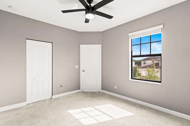 unfurnished bedroom featuring a closet, ceiling fan, baseboards, and carpet floors