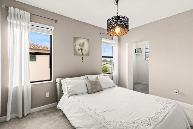 bedroom featuring multiple windows, baseboards, and carpet