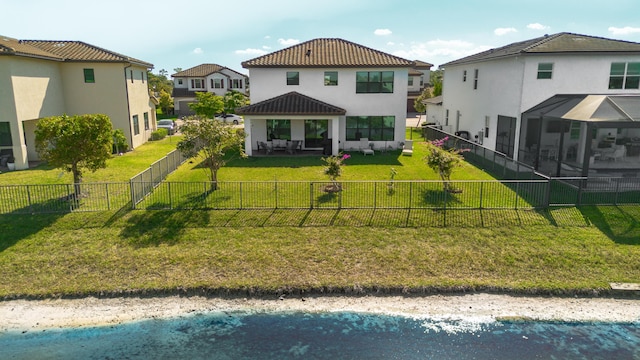 back of property featuring stucco siding, a yard, a fenced backyard, and a tile roof