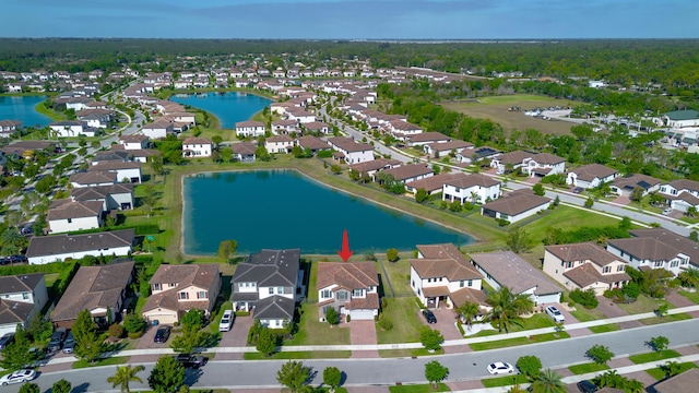 bird's eye view featuring a residential view and a water view