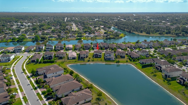 drone / aerial view with a residential view and a water view