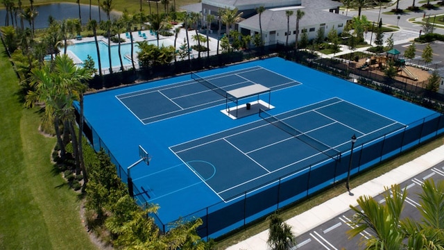 view of sport court featuring fence